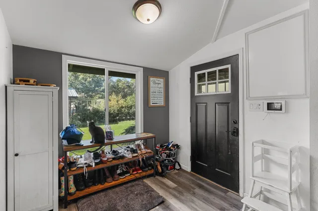 a view of a livingroom with wooden floor and a window