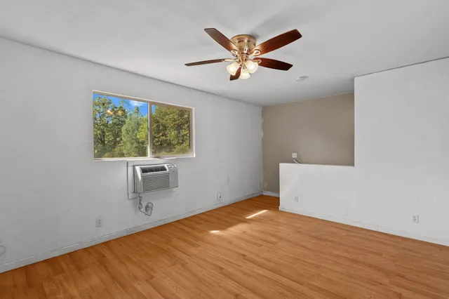 a view of empty room with wooden floor