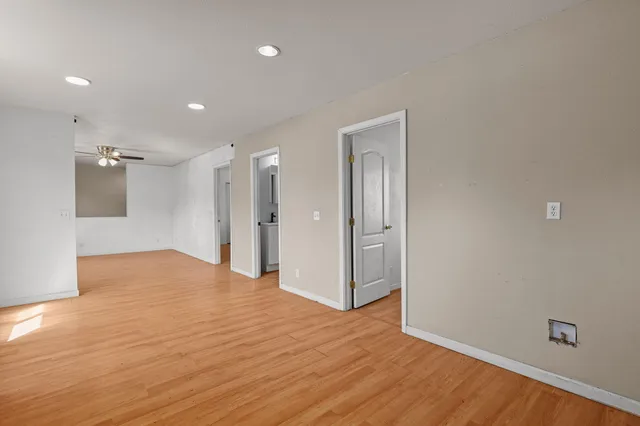 a view of empty room with wooden floor