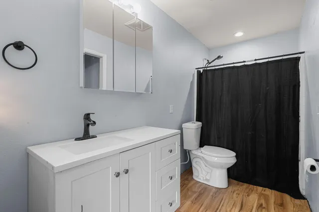 a bathroom with a sink toilet and vanity