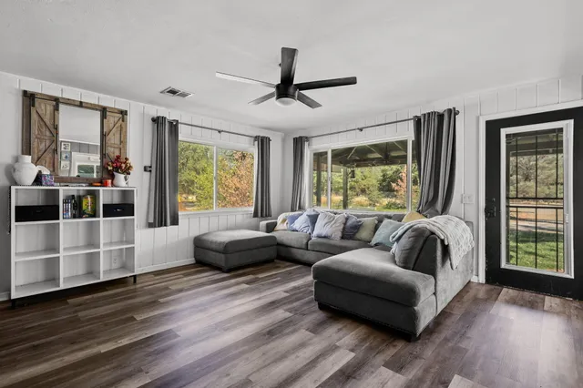 a living room with furniture and a large window