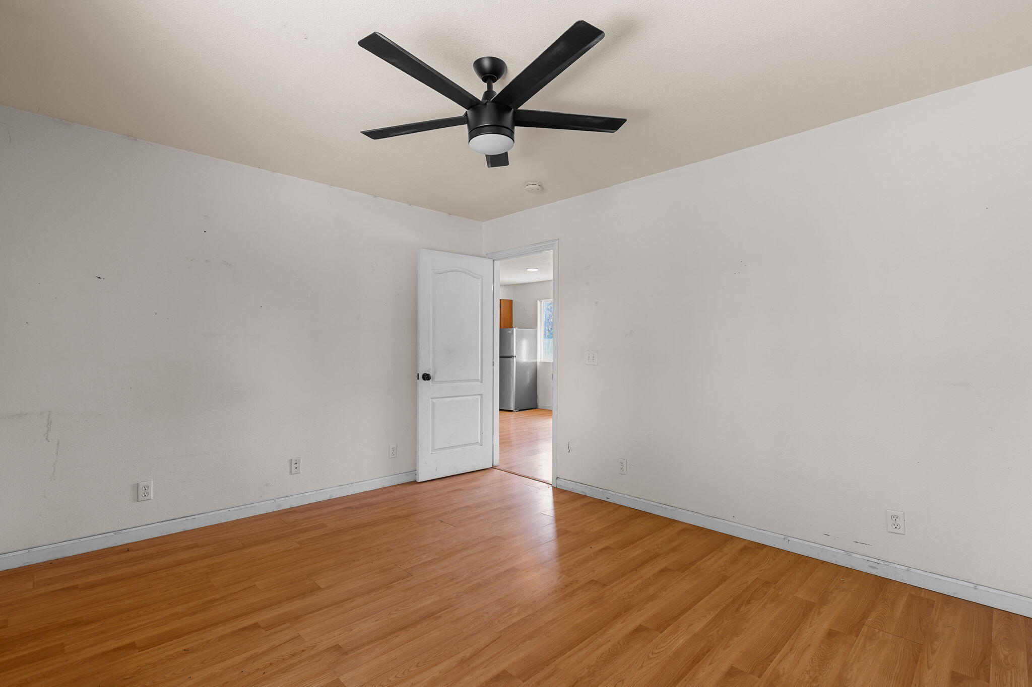 28093 Highway 44 Shingletown, CA 96088 - Photo 31 of 42 an empty room with wooden floor and ceiling fan