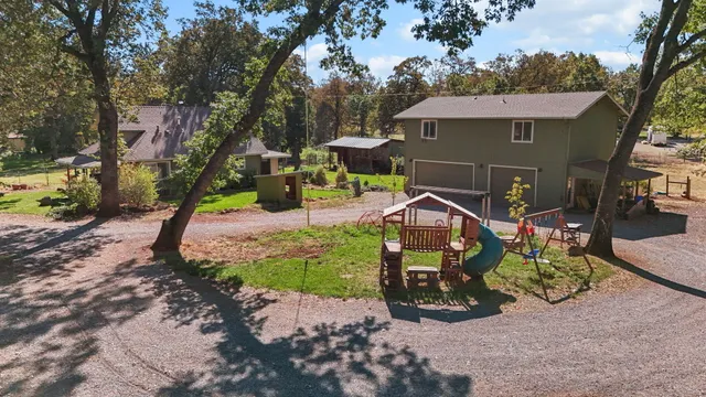 an outdoor space with seating area and trees around