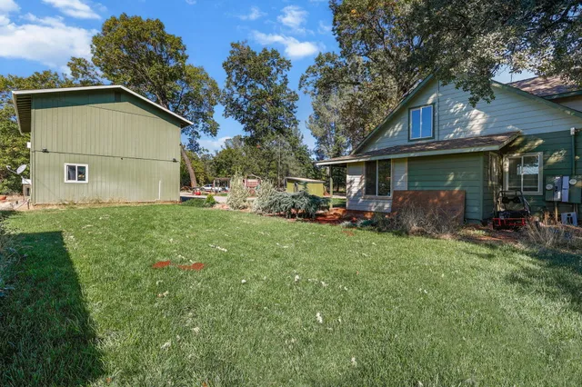 a front view of house with yard and trees