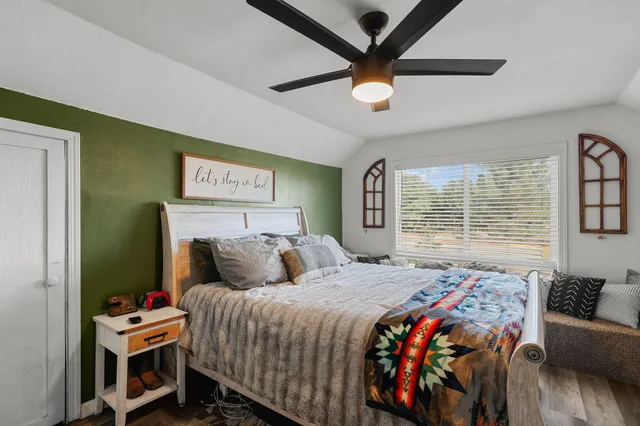 a bedroom with a bed and a chandelier