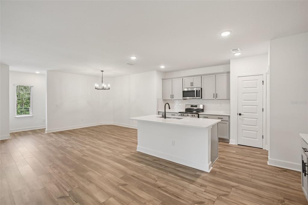 3033 Magellan Avenue Spring Hill, FL 34608 - Photo 18 of 42 a view of kitchen with wooden floor and electronic appliances