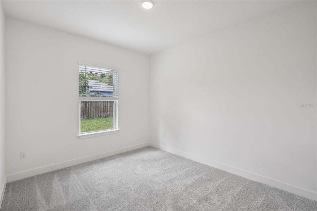 3033 Magellan Avenue Spring Hill, FL 34608 - Photo 27 of 42 an empty room with windows