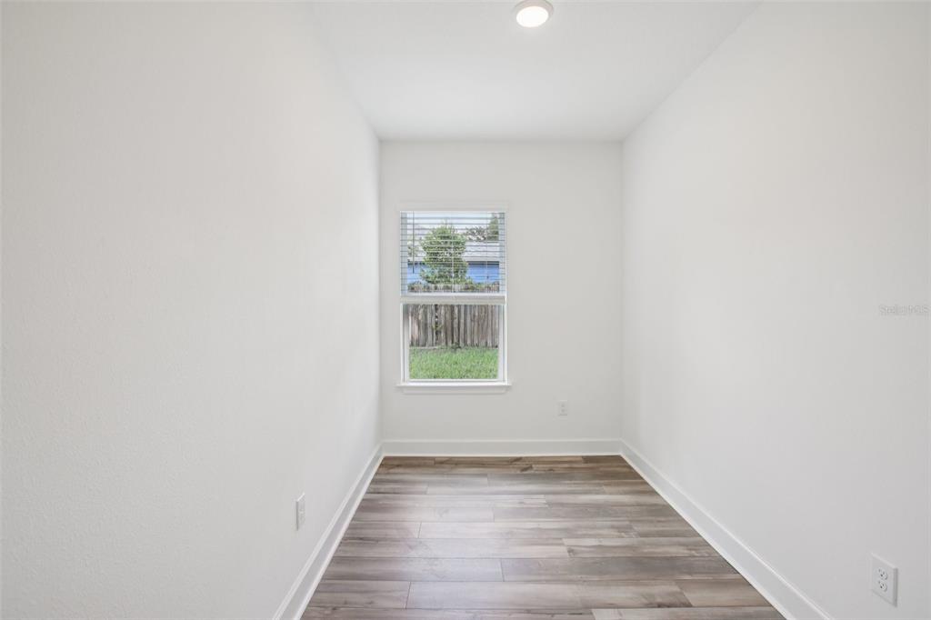 3033 Magellan Avenue Spring Hill, FL 34608 - Photo 29 of 42 a view of a hallway with wooden floor and a window