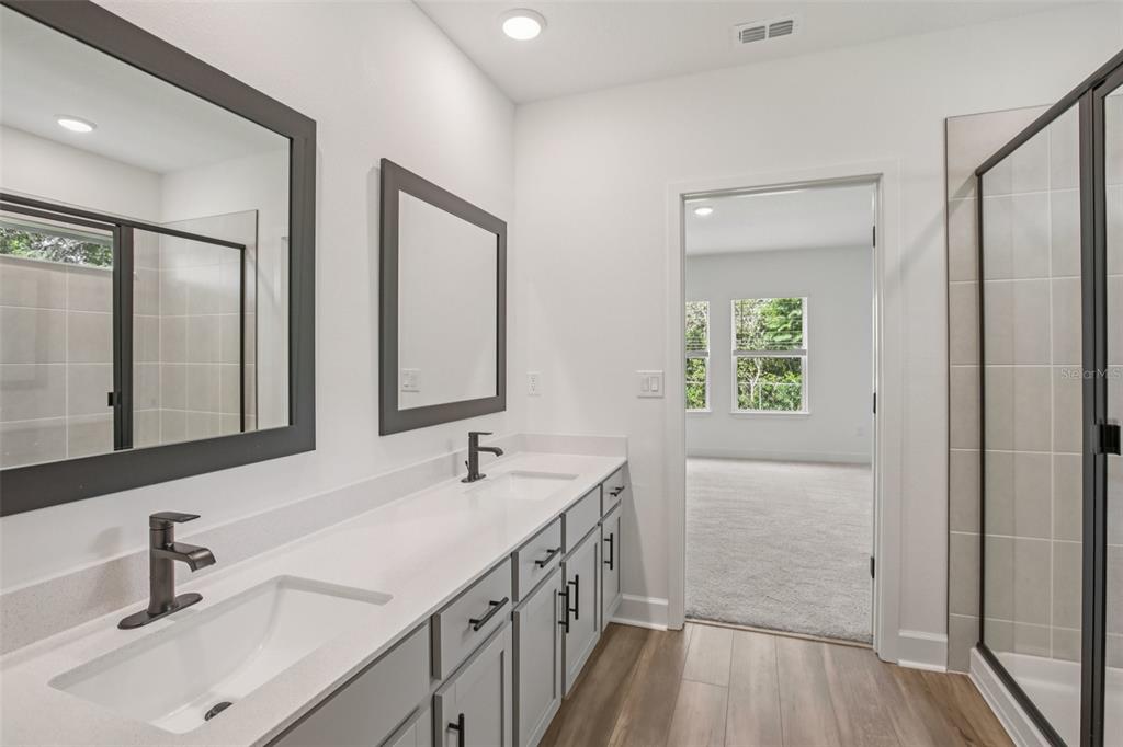 3033 Magellan Avenue Spring Hill, FL 34608 - Photo 38 of 42 a bathroom with a double vanity sink and a mirror