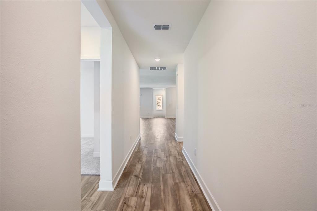 3033 Magellan Avenue Spring Hill, FL 34608 - Photo 5 of 42 a view of a hallway with wooden floor