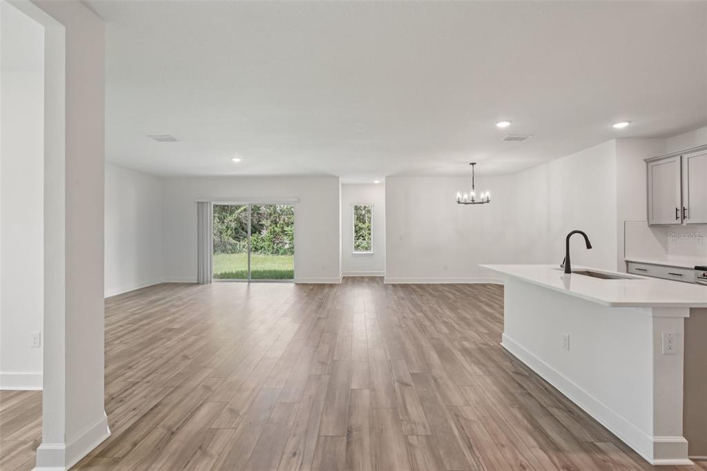 3033 Magellan Avenue Spring Hill, FL 34608 - Photo 6 of 42 a view of a kitchen with wooden floor and windows