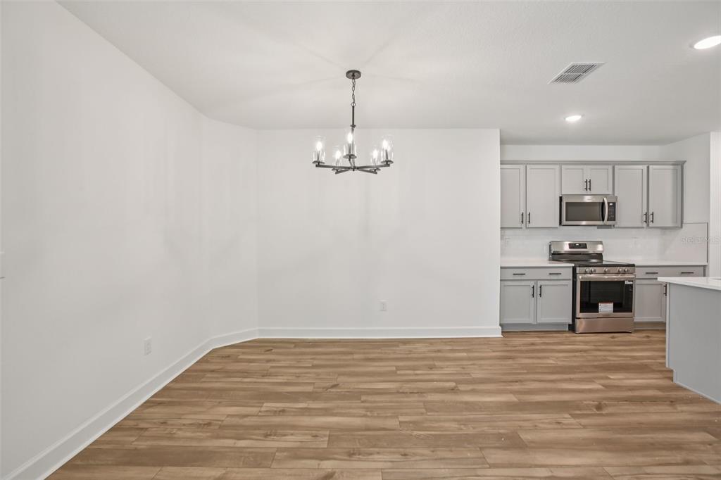 3033 Magellan Avenue Spring Hill, FL 34608 - Photo 9 of 42 a view of a kitchen with a sink a refrigerator and window