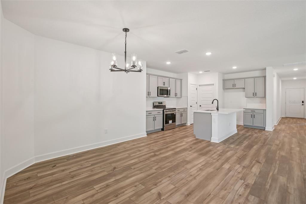 3033 Magellan Avenue Spring Hill, FL 34608 - Photo 10 of 42 a view of a kitchen with wooden floor