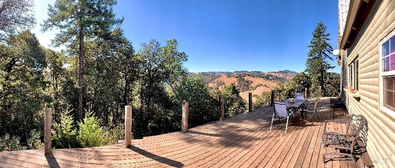 37600 Highway 101 Willits, CA 95490 - Photo 2 of 22 a view of a patio with table and chairs with wooden floor and fence