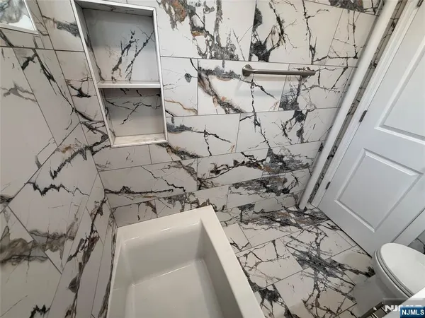 a bathroom with a toilet sink and shower