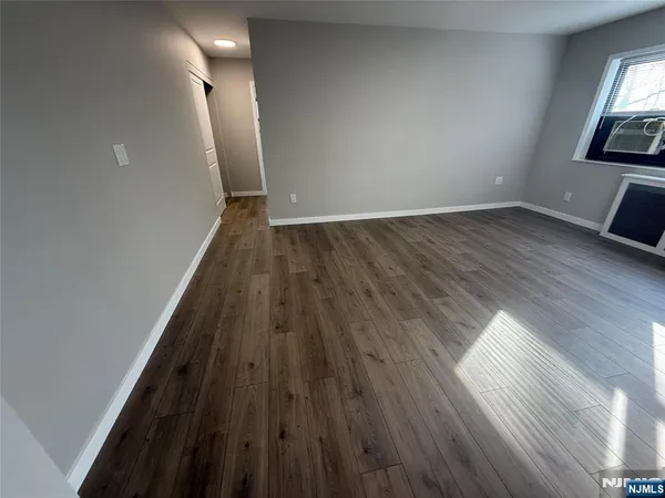 wooden floor in a hall with an empty room