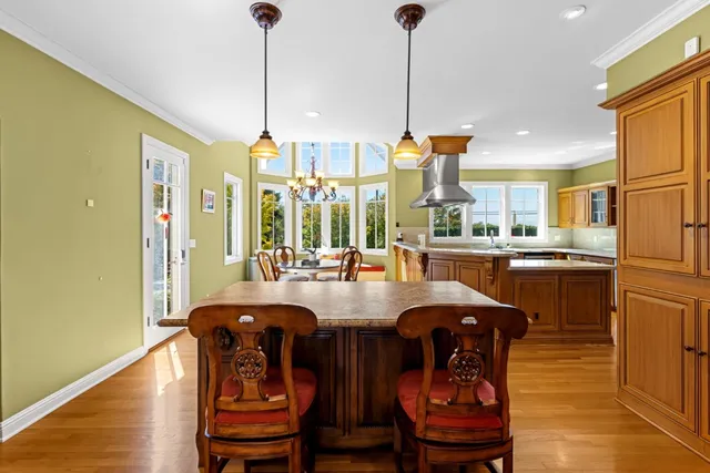 a dining table with chairs and window