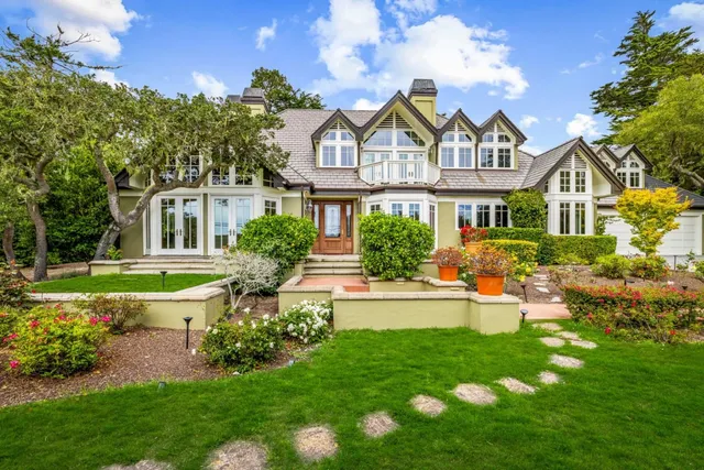 a front view of a house with a garden