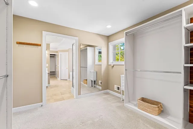 a view of walk in closet with clothes and shoes