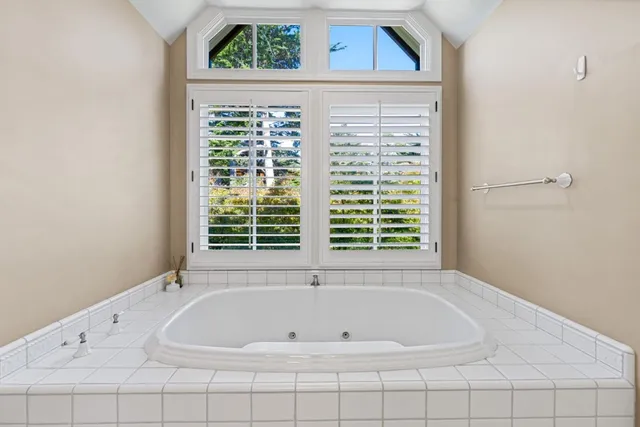 a spacious bathroom with a sink a mirror and a bathtub
