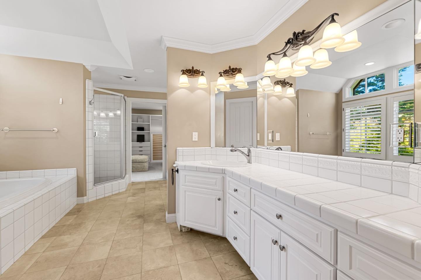 3937 Ronda Road Pebble Beach, CA 93953 - Photo 33 of 46 a spacious bathroom with a sink a mirror and a bathtub