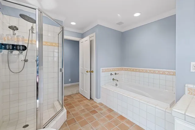 a bedroom with furniture and a large window