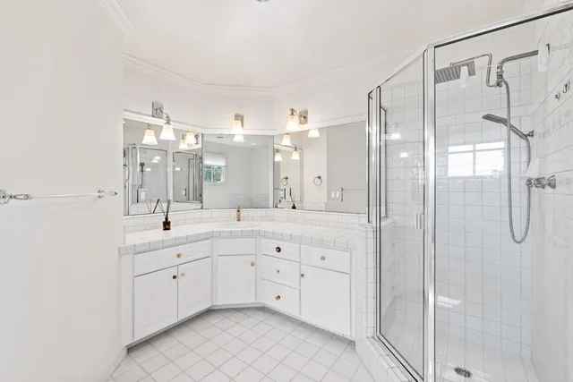 a bedroom with a large bed and wooden floor