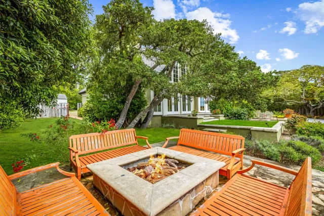 a view of a backyard with sitting area