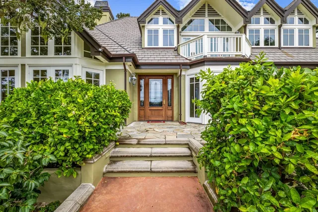 a front view of a house with a garden