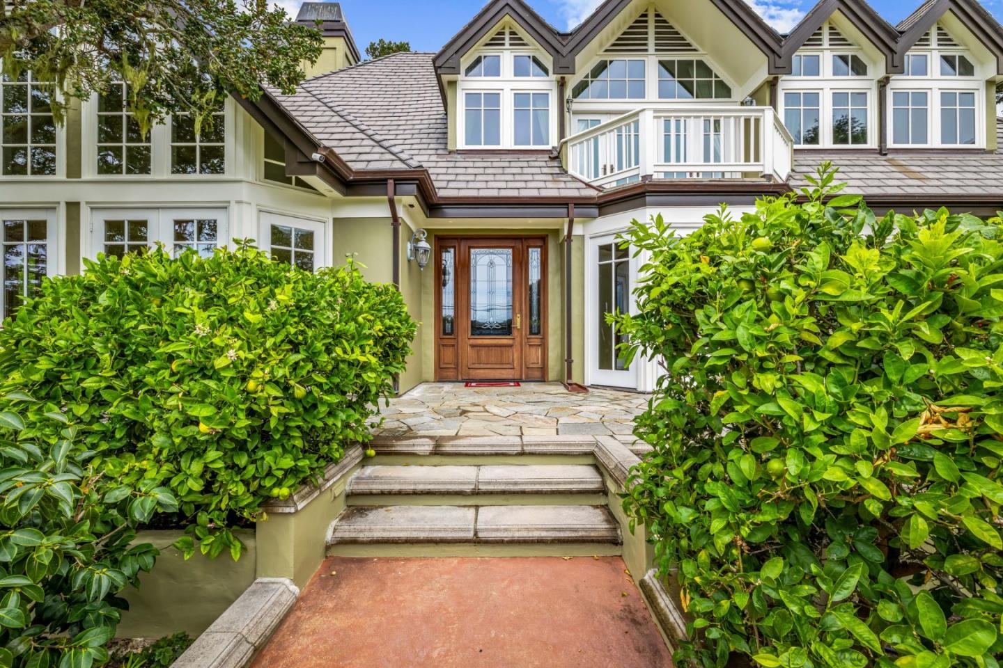 3937 Ronda Road Pebble Beach, CA 93953 - Photo 5 of 46 a front view of a house with a garden