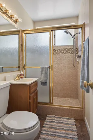 a bathroom with a toilet a sink and a shower