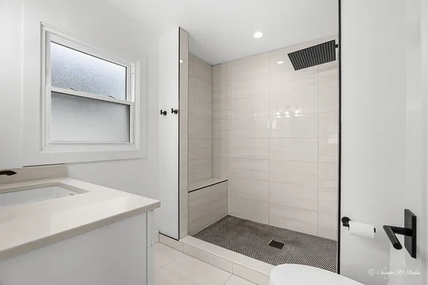 a bathroom with a shower sink and mirror
