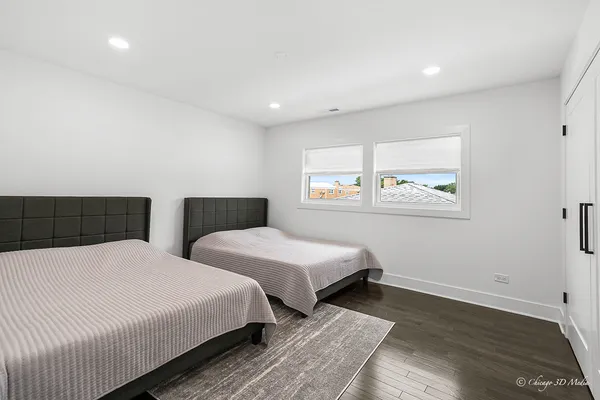 a bedroom with two beds and a window