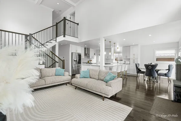 a living room with furniture and kitchen view
