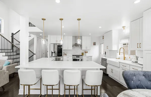 a large kitchen with a table and chairs