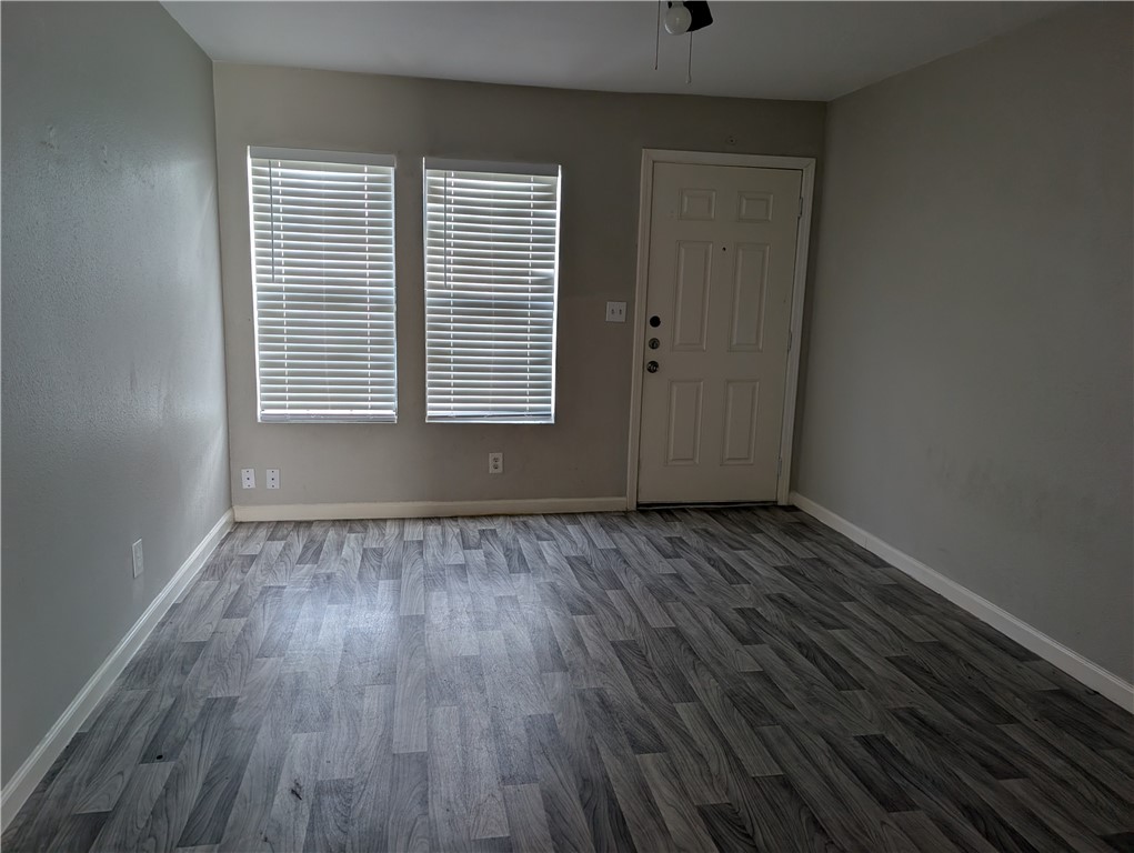 117 Edwards Street Corpus Christi, TX 78404 - Photo 2 of 6 a view of an empty room with wooden floor and a window