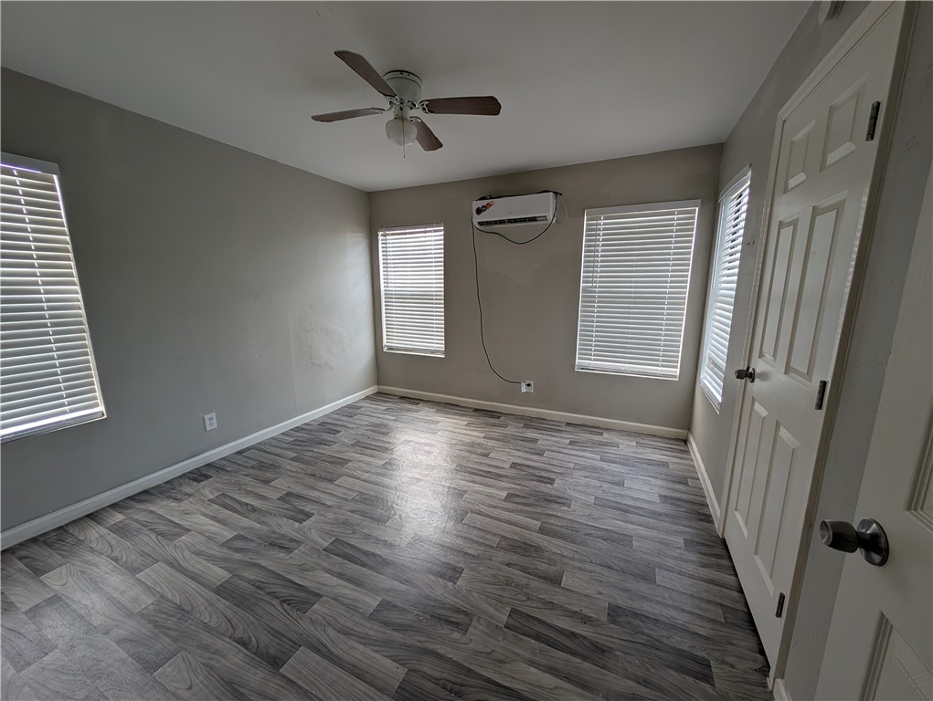117 Edwards Street Corpus Christi, TX 78404 - Photo 3 of 6 a view of empty room with wooden floor and fan