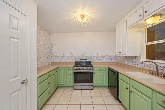 a kitchen with a stove sink and cabinets