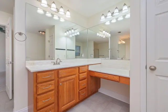 a bathroom with a double vanity sink and a mirror