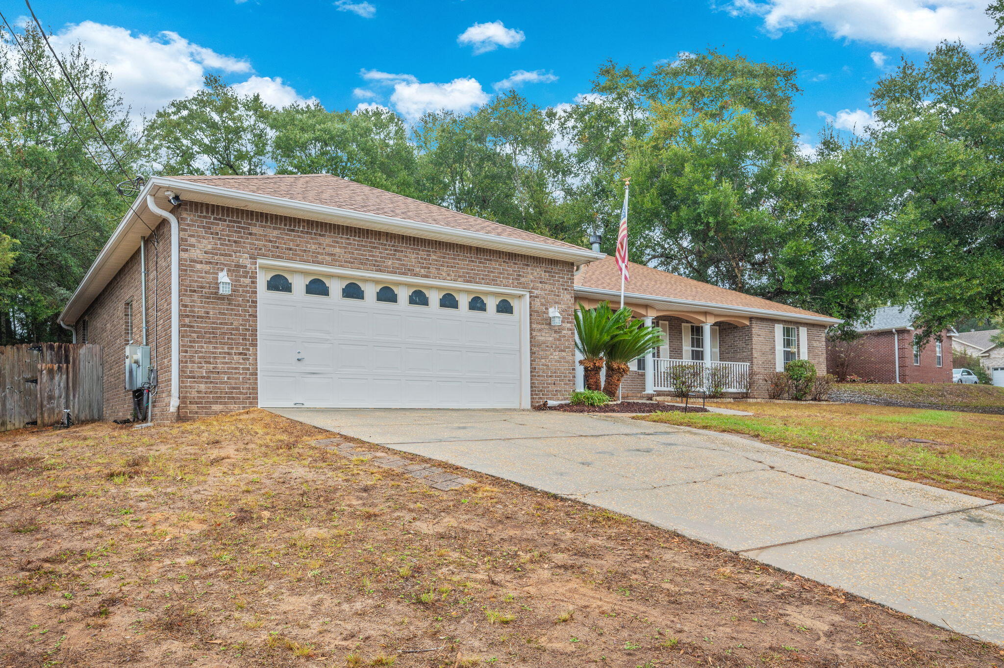 231 Seneca Trail Crestview, FL 32536 - Photo 2 of 39 a front view of a house with a yard and garage