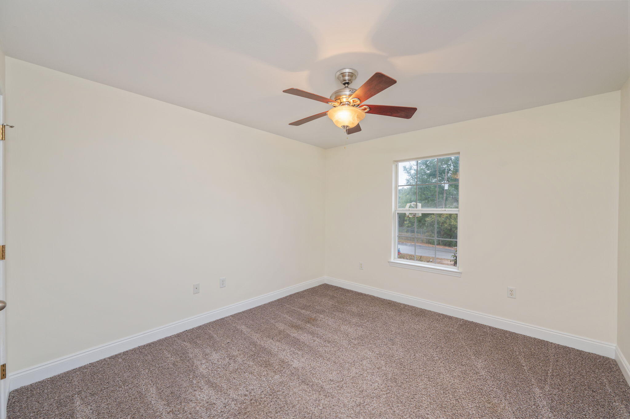 231 Seneca Trail Crestview, FL 32536 - Photo 26 of 39 an empty room with a window and ceiling fan