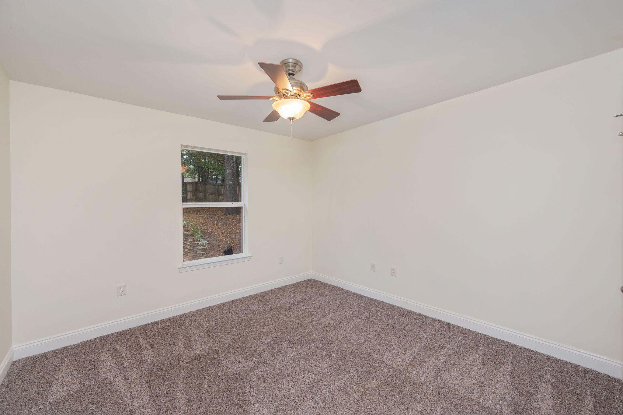 231 Seneca Trail Crestview, FL 32536 - Photo 29 of 39 an empty room with a window and a fan