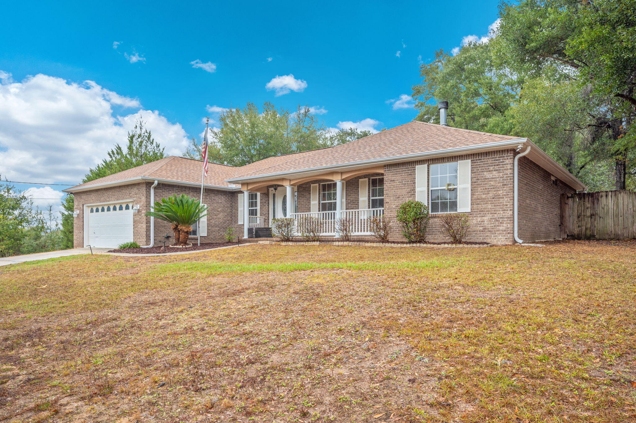 231 Seneca Trail Crestview, FL 32536 - Photo 3 of 39 a front view of a house with a garden