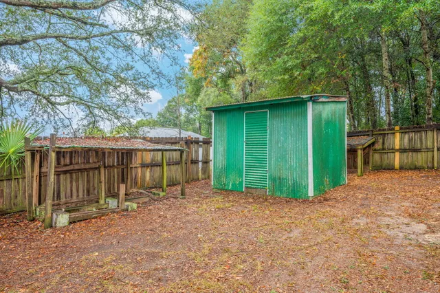 a view of a backyard with small cabin