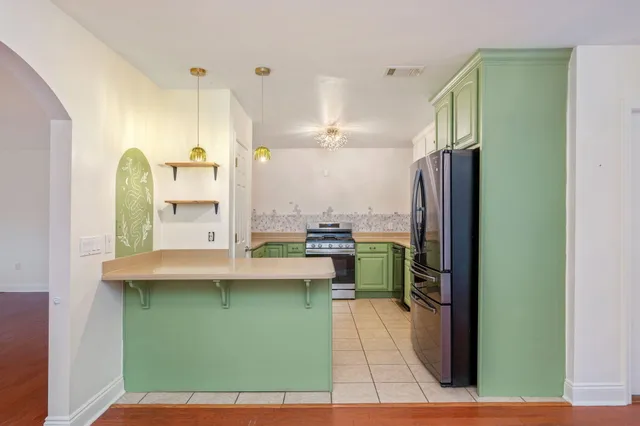 a kitchen with a refrigerator and a sink