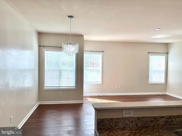 a room with a window and wooden floor