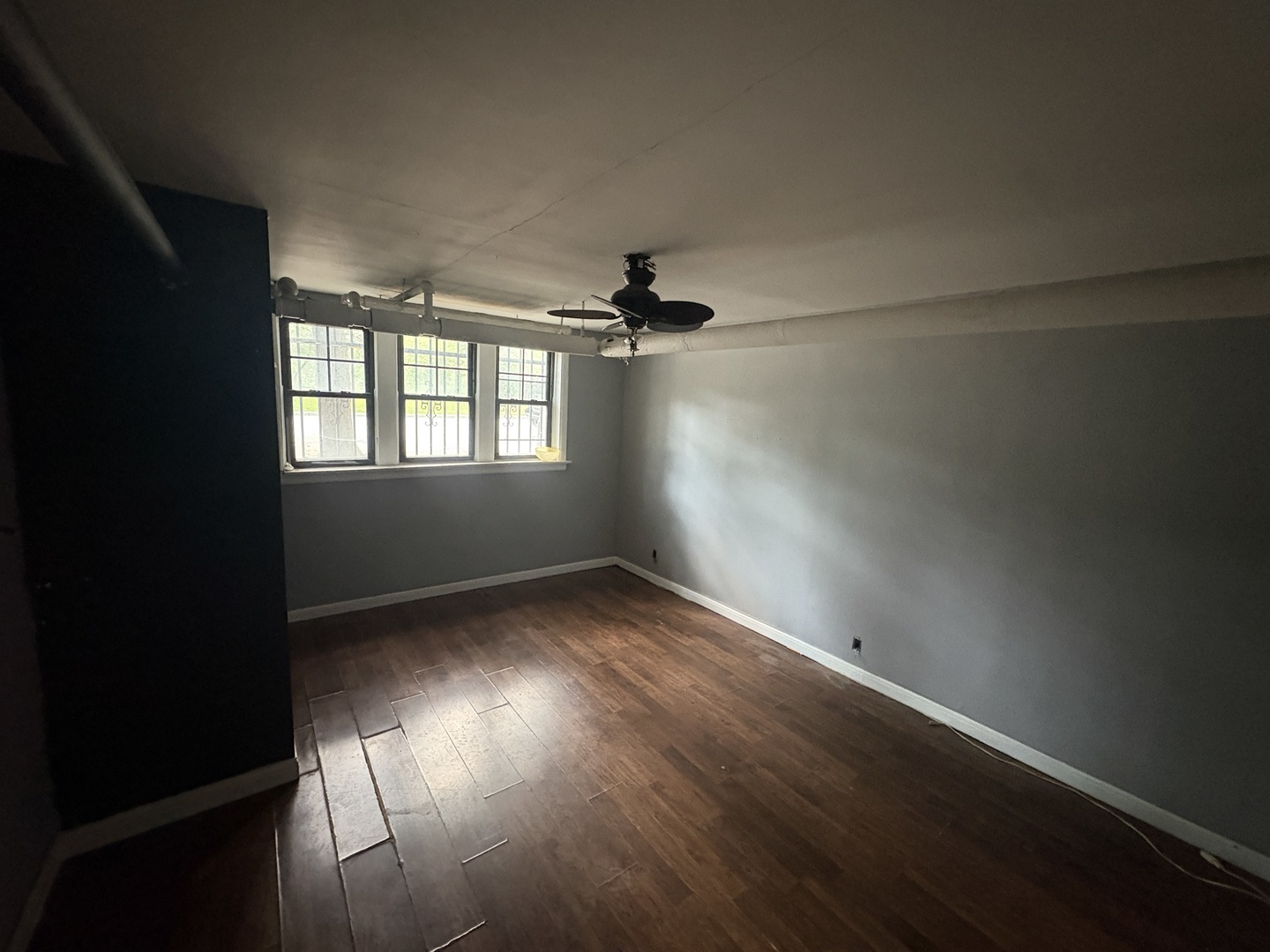 3316 West 67th Street, Unit GARDEN Chicago, IL 60629 - Photo 4 of 5 an empty room with wooden floor and windows