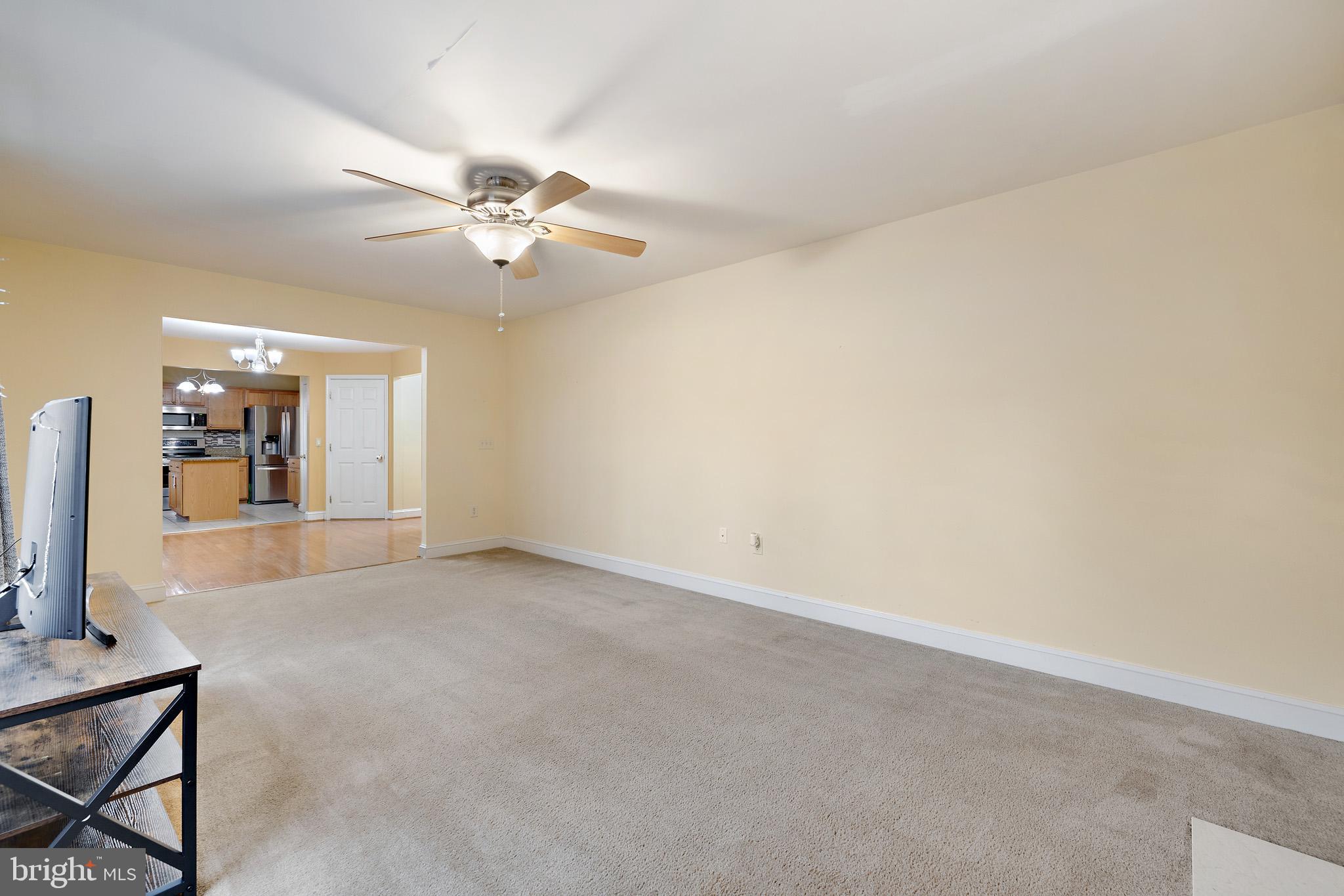 8008 Carlean Court Pasadena, MD 21122 - Photo 12 of 35 an empty room with a ceiling fan and a window