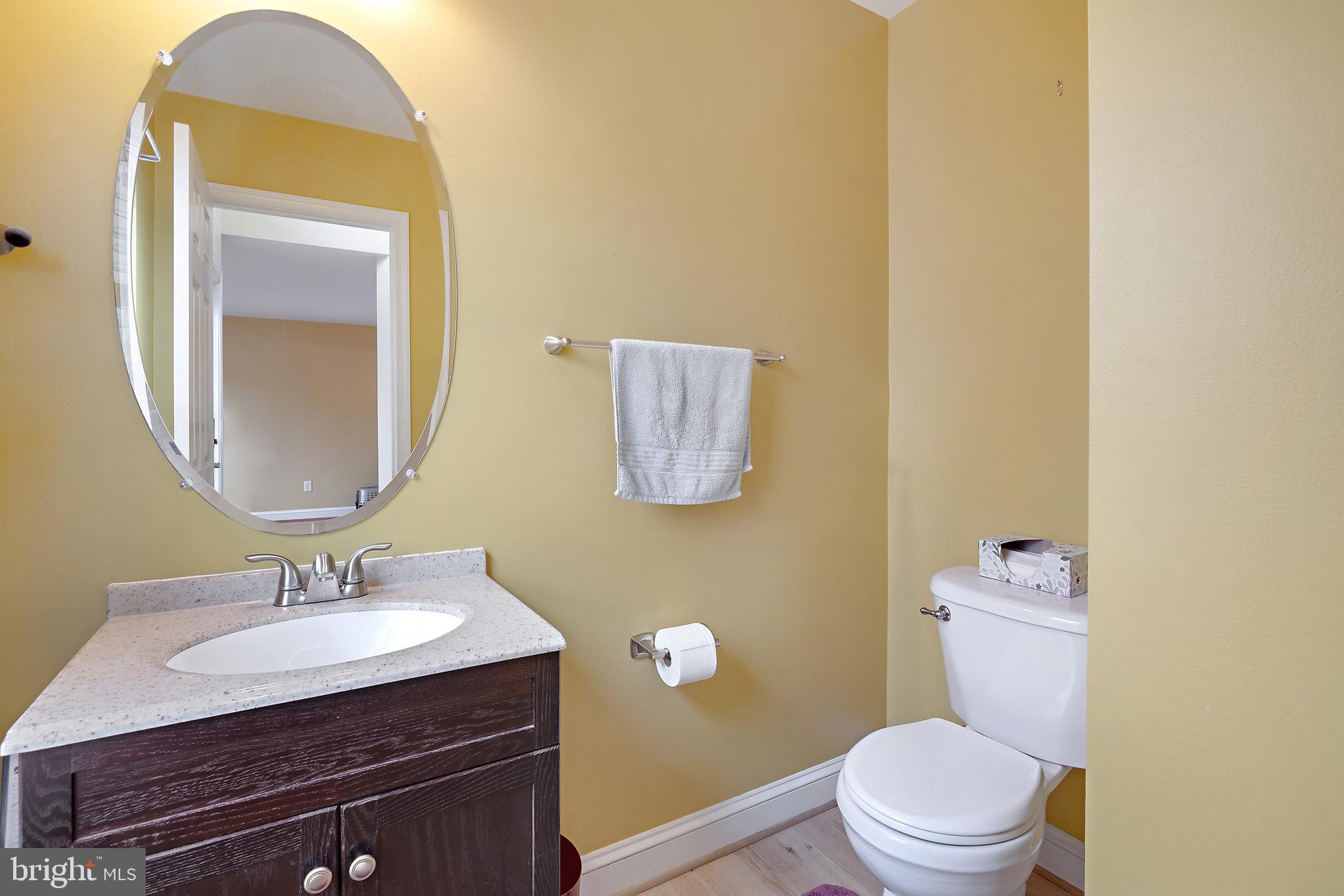 8008 Carlean Court Pasadena, MD 21122 - Photo 13 of 35 a bathroom with a sink vanity mirror and toilet