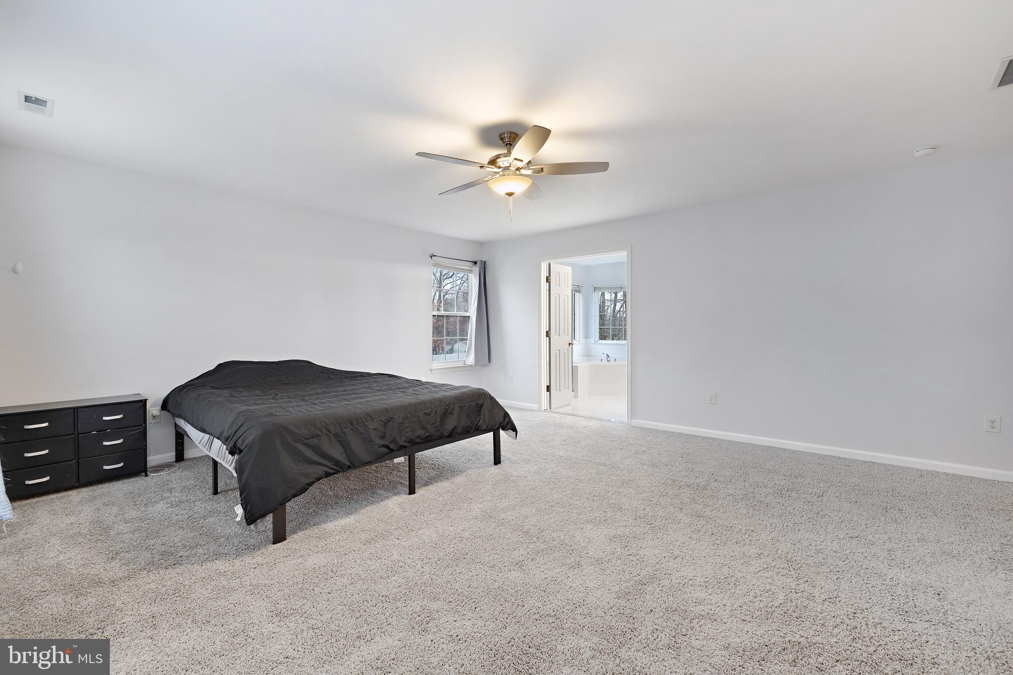 8008 Carlean Court Pasadena, MD 21122 - Photo 17 of 35 a bedroom with a bed and a ceiling fan